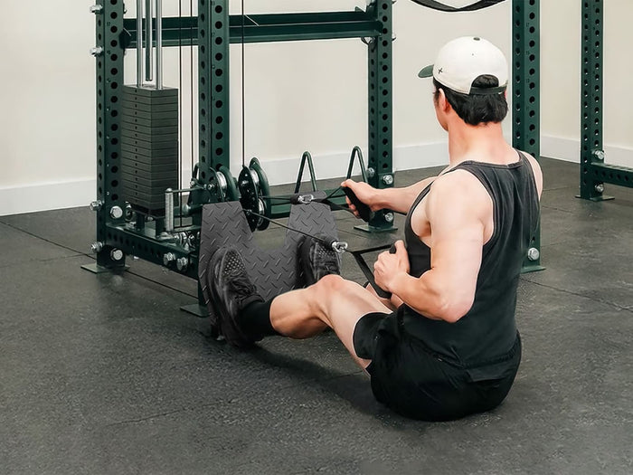 Gym Plus Evolve Footrest Rack Attachment 75-FOOTREST a man performing cable row with footrest